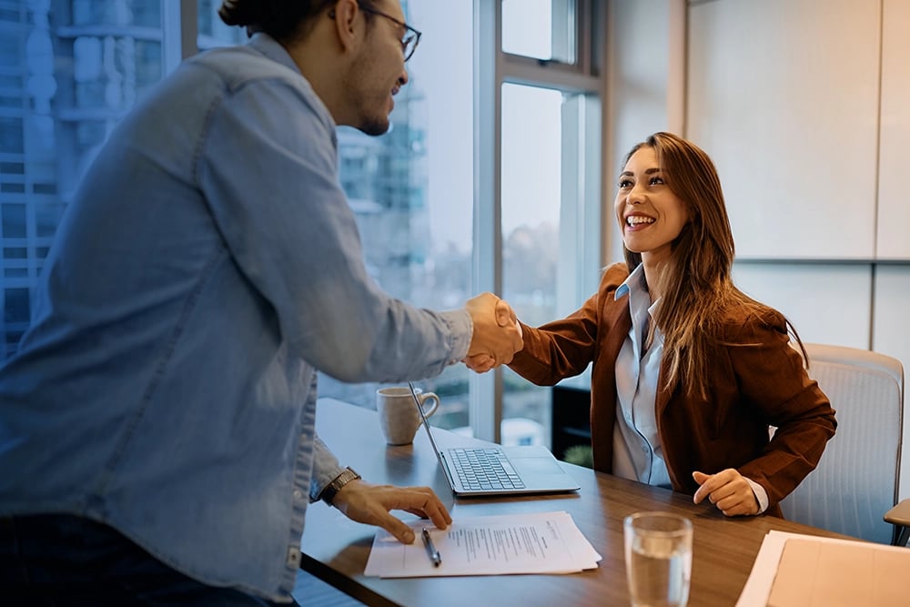 employee and employer shaking hands