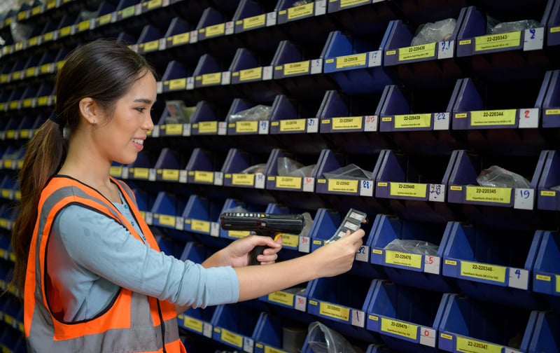 female-warehouse-worker-counting-small-parts-store-2025-01-08-23-48-14-utc